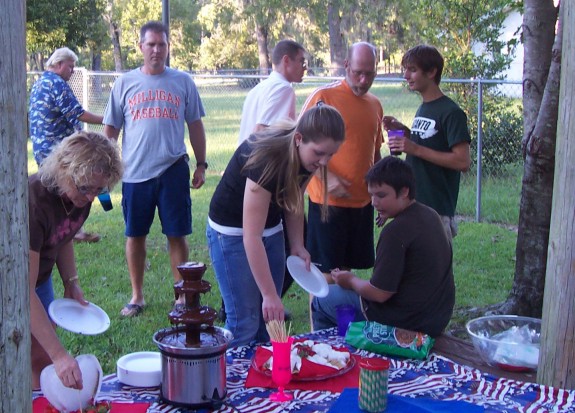 Fred (gray t-shirt) says, "I hope they don't eat it all before I get there."